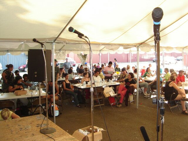 A crowd waits for a world premiere broadcast after the Pineros y Campesinos Unidos del Noroeste Barnraising in Woodburn, OR. Photo credit: The Prometheus Radio Project.