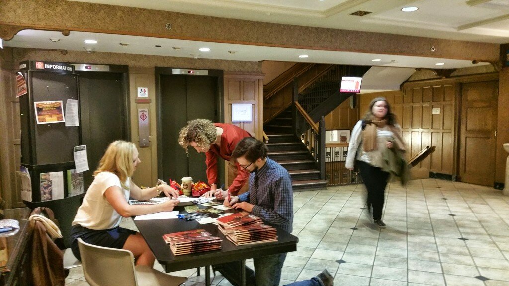 Elizabeth Bartels working with students who are completing postcards at John Marshall Law School